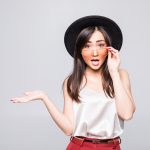 young-asian-woman-with-sunglasses-gesture-with-hands-isolated-white-wall-150x150