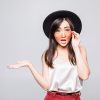 Young asian woman with sunglasses gesture with hands on white background